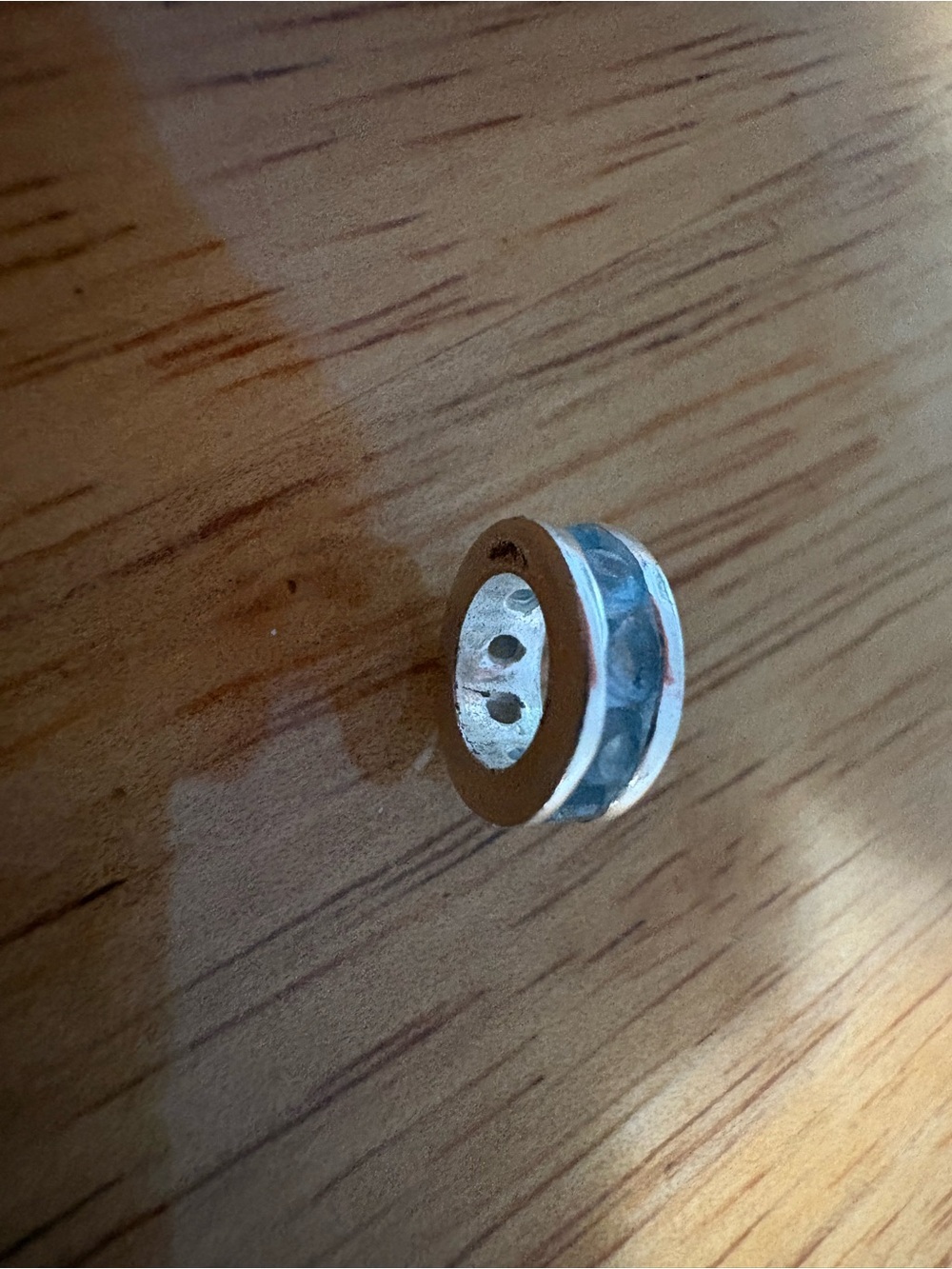 Sterling silver pandora style charm with light blue stones.